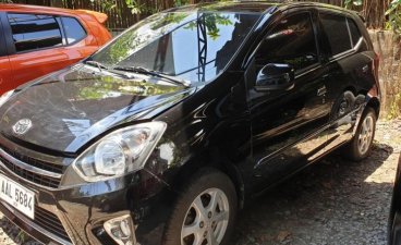 Selling Black Toyota Wigo 2014 Automatic Gasoline at 20000 km in Quezon City